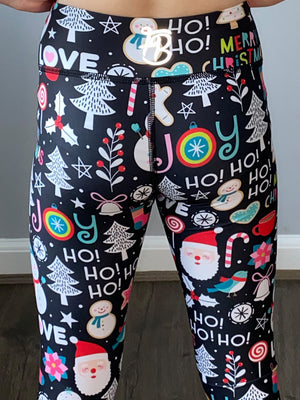 Kids christmas leggings that have different christmas pictures all over including santa, candy canes and snowmen. Close up of pattern